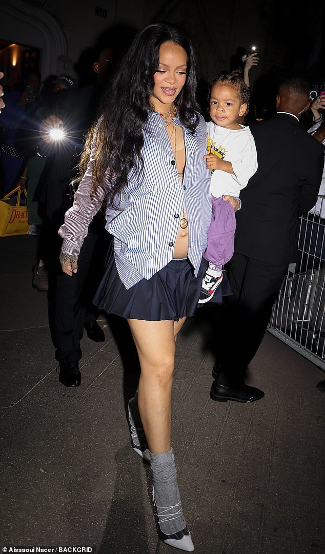 99806795-14855597-rihanna-showed-off-her-growing-baby-bump-in-an-unbuttoned-shirt-a-17-1751098309124.jpg