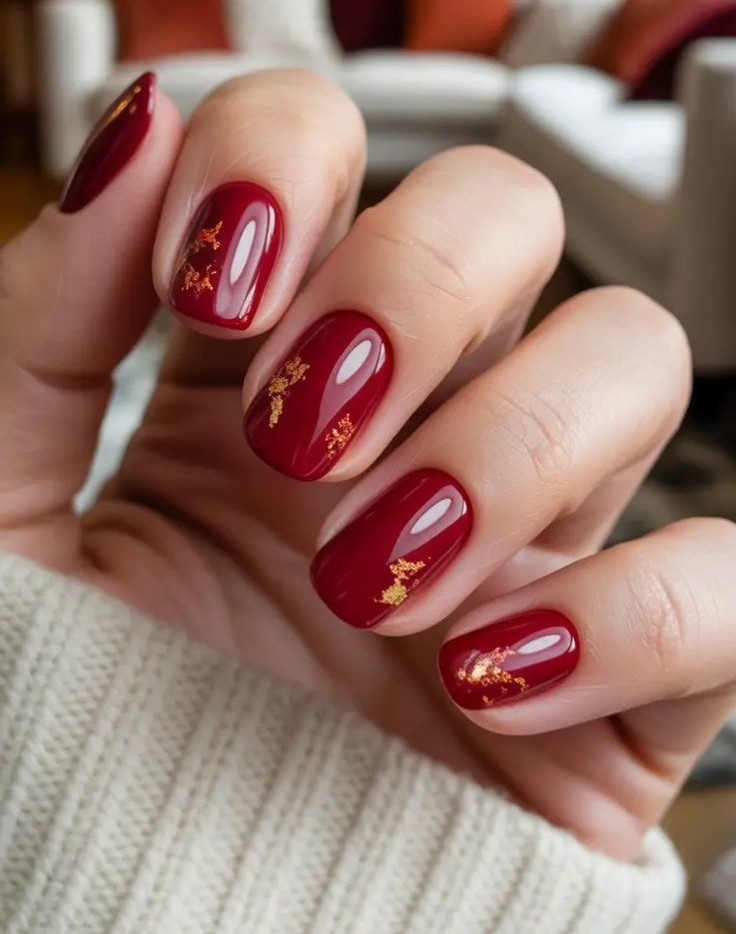 red-fall-nails-2025-deep-red-nails-with-gold-foil-accents-cozy-autumn-manicure-ideas.jpg