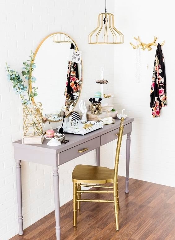 a-grey-desk-with-a-mirror-over-it-and-many-make-up-on-it-paired-with-a-golden-metal-chair.jpg